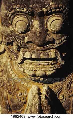 Stock Photo - Close up a stone carving of a face; Hawaii, United States of America. Fotosearch