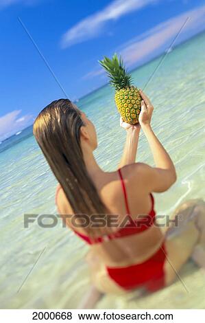 Close-Up Back View Of Woman Sitting In Water, Holding Pineapple In Hands, Blue Sky View Large Photo Image Stock Photo - Close-Up Back View Of Woman Sitting In Water, Holding Pineapple In Hands, Blue Sky. Fotosearch