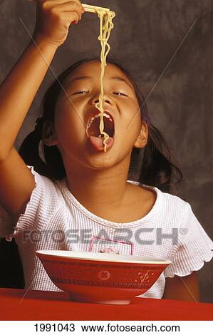 Close-Up Front View Of Local Asian-American Girl Eating Saimin Noodles, Mouth Wide Open View Large Photo Image Stock Image - Close-Up Front View Of Local Asian-American Girl Eating Saimin Noodles, Mouth Wide Open. Fotosearch
