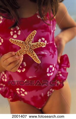 Close-Up Girl Pink Bathing Suit Holding Starfish In Front, Hand On Hip View Large Photo Image Stock Photo - Close-Up Girl Pink Bathing Suit Holding Starfish In Front, Hand On Hip. Fotosearch