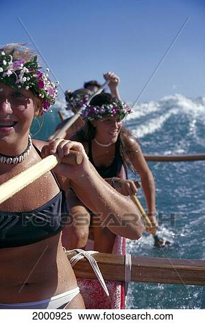 Close-Up Girls Wearing Haku Lei Paddling Outrigger Canoe, Wave Behind Them View Large Photo Image Stock Photography - Close-Up Girls Wearing Haku Lei Paddling Outrigger Canoe, Wave Behind Them. Fotosearch