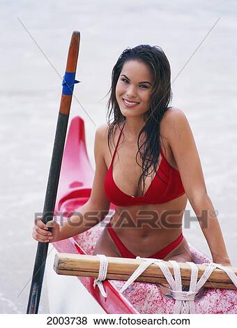 Stock Photo - Close-Up Local Woman Sitting In Outrigger Canoe Holding Paddle. Fotosearch