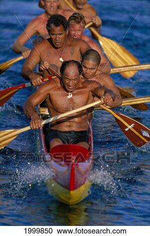 Stock Image - Close-Up Men Paddling Outrigger Canoe Splash On Bow Shirtless. Fotosearch