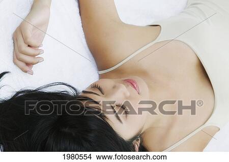 Picture - Close-Up Of A Beautiful Asian Woman Laying Down.. Fotosearch