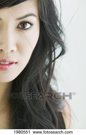 Stock Image - Close-Up Of A Beautiful Asian Woman, Half Of Face.. Fotosearch