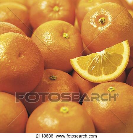 Stock Photograph - Close-Up Of A Bunch Of Oranges And One Slice. Fotosearch