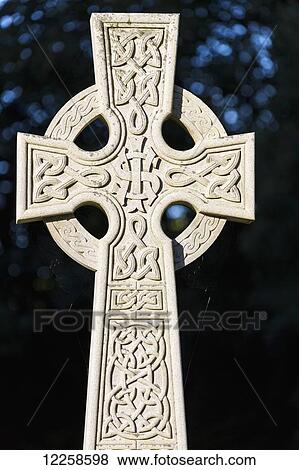 Stock Photo - Close up of a celtic cross and dark background; Kilrush, County Clare, Ireland. Fotosearch