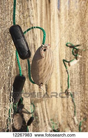 Close up of a fishing net and buoys hanging in the sun to dry, Shungnak, Arctic Alaska, Summer View Large Photo Image Stock Image - Close up of a fishing net and buoys hanging in the sun to dry, Shungnak, Arctic Alaska, Summer. Fotosearch
