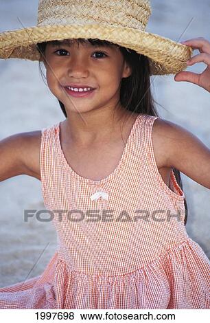 Close-Up Of A Little Girl In Peach Dress, With Straw Hat, Smiling View Large Photo Image Stock Photo - Close-Up Of A Little Girl In Peach Dress, With Straw Hat, Smiling. Fotosearch