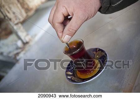 Close-Up Of A Men's Hand Stiring Tea At Tea Stall In Sulaymaniyah, Iraqi Kurdistan, Iraq View Large Photo Image Stock Image - Close-Up Of A Men's Hand Stiring Tea At Tea Stall In Sulaymaniyah, Iraqi Kurdistan, Iraq. Fotosearch
