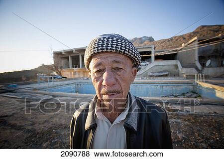 Stock Photo - Close-Up Of A Senior Man With Squatted Building Outside Amadiya In Iraqi Kurdistan, Iraq. Fotosearch