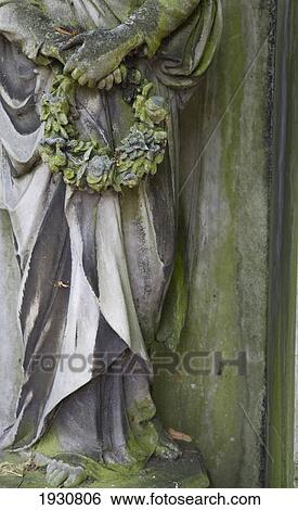 Stock Photograph - Close-Up Of A Statue On A Tomb In Brompton Cemetery; London, England. Fotosearch