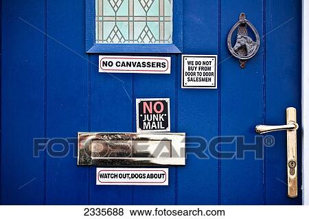 Stock Photo - Close Up Of Blue Door With Signs. Fotosearch