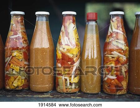 Picture - Close-Up Of Bottles Of Pepper Sauce. Fotosearch