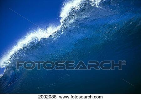 Close-Up Of Clear Wave About To Break With Spray Against Blue Sky View Large Photo Image Stock Photo - Close-Up Of Clear Wave About To Break With Spray Against Blue Sky. Fotosearch