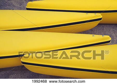 Close-Up Of Four Yellow Paddleboat Hulls Side By Side View Large Photo Image Stock Photo - Close-Up Of Four Yellow Paddleboat Hulls Side By Side. Fotosearch
