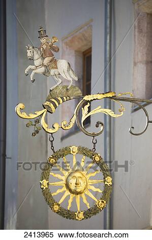 Close up of gold sign with a sun, horn, and person on a horse; Rattenberg, Austria View Large Photo Image Stock Photography - Close up of gold sign with a sun, horn, and person on a horse; Rattenberg, Austria. Fotosearch