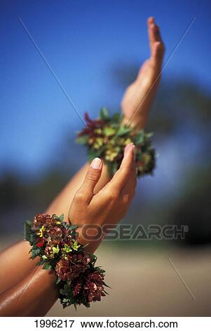 Stock Photo - Close-Up Of Hula Hands With Flower Bracelets. Fotosearch