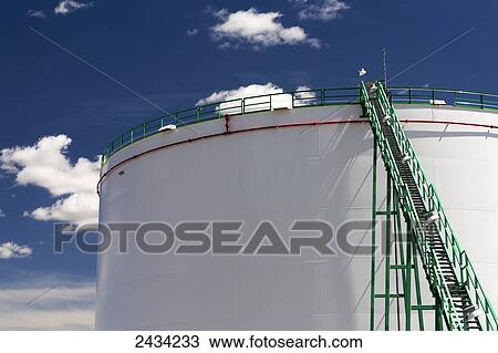 Close up of large white storage oil tank with staircase and blue sky and clouds; Caresland, Alberta, Canada View Large Photo Image Stock Image - Close up of large white storage oil tank with staircase and blue sky and clouds; Caresland, Alberta, Canada. Fotosearch