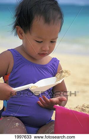 Close-Up Of Little Girl In Purple Bathing Suit Playing In Sand, Bucket And Shovel View Large Photo Image Stock Image - Close-Up Of Little Girl In Purple Bathing Suit Playing In Sand, Bucket And Shovel. Fotosearch