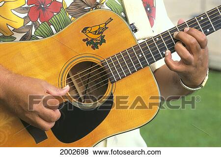 Stock Photo - Close-Up Of Mans Hands Playing Slack Key Guitar. Fotosearch