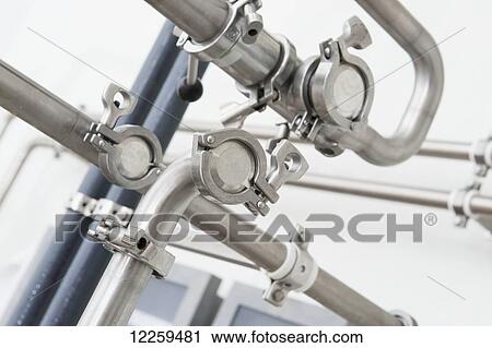 Stock Image - Close up of metal pipes for making ice cream; Baltimore, Maryland, United States of America. Fotosearch