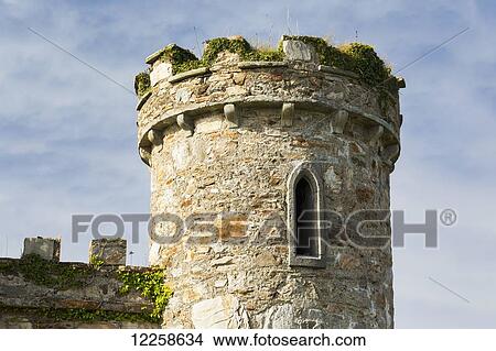 Picture - Close up of old castle stone turret with blue sky and clouds; Clifden, County Galway, Ireland. Fotosearch
