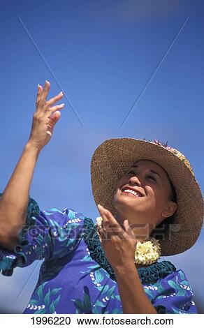 Stock Image - Close-Up Of Older Hawaiian Woman (Tutu) Dancing On Beach, Hands In Air. Fotosearch