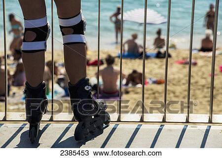 Close up of roller skater on the promenade at a railing overlooking Barceloneta beach; Barcelona, Catalonia, Spain View Large Photo Image Stock Image - Close up of roller skater on the promenade at a railing overlooking Barceloneta beach; Barcelona, Catalonia, Spain. Fotosearch