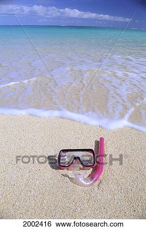 Stock Photograph - Close-Up Of Snorkel And Mask On Empty Beach, Clear Shore Water, Blue Sky. Fotosearch