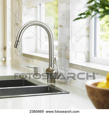 Close-up of stainless steel kitchen faucet with marble subway backsplash; Victoria, Vancouver Island, British Columbia View Large Photo Image Stock Photo - Close-up of stainless steel kitchen faucet with marble subway backsplash; Victoria, Vancouver Island, British Columbia. Fotosearch