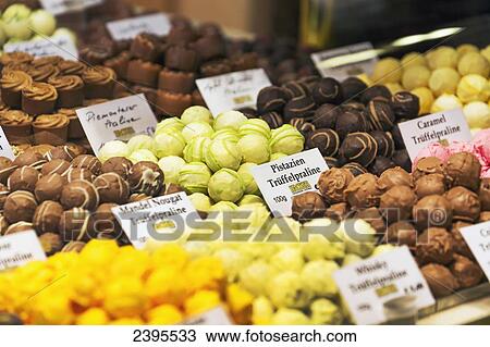Stock Image - Close up of store display with colourful chocolate truffle balls; Rattenberg, Austria. Fotosearch