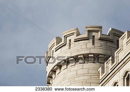 Stock Image - Close Up Of The Top Of A Castle Turret With Blue Sky And Clouds; Toronto, Ontario, Canada. Fotosearch
