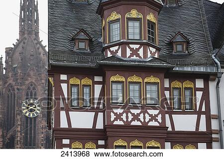Stock Photo - Close up of tudor style building front with details and Cathedral tower in background; Frankfurt am Main, Germany. Fotosearch