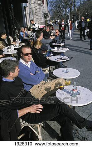 Stock Image - Close-Up Of Two Men Outside Cafe Einstein. Fotosearch