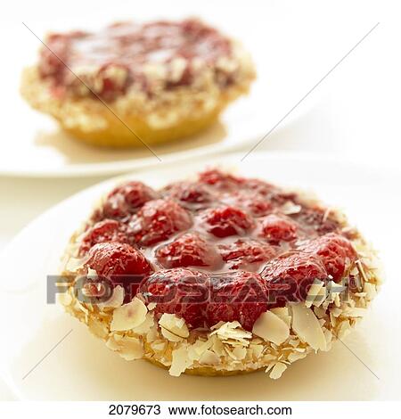 Close-Up Of Two Raspberry Tarts On White Plates. View Large Photo Image Stock Image - Close-Up Of Two Raspberry Tarts On White Plates.. Fotosearch
