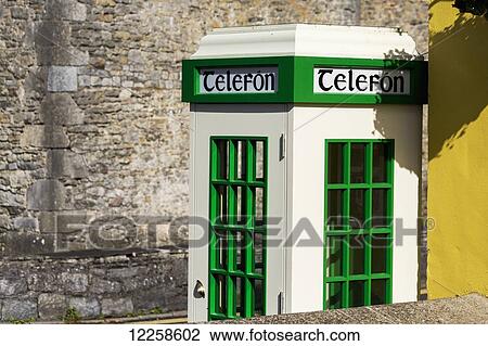 Close up of white telephone booth with green trim against a stone wall; Bunratty, County Clare, Ireland View Large Photo Image Stock Image - Close up of white telephone booth with green trim against a stone wall; Bunratty, County Clare, Ireland. Fotosearch