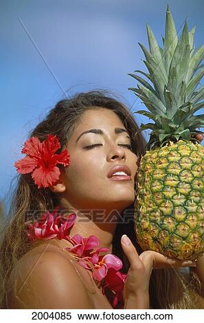 Close-Up Of Woman Holding Pineapple, Eyes Closed Wearing Pink Plumeria Lei Hibiscus Flower In Ear View Large Photo Image Stock Photography - Close-Up Of Woman Holding Pineapple, Eyes Closed Wearing Pink Plumeria Lei Hibiscus Flower In Ear. Fotosearch