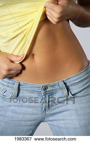 Stock Photo - Close-Up Of Womans Tanned And Toned Midsection.. Fotosearch