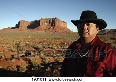 Close-up on Larry Holiday, a Navajo guide, and Rain God Mesa, Monument Valley, Utah, Arizona., Utah, Arizona. View Large Photo Image Stock Image - Close-up on Larry Holiday, a Navajo guide, and Rain God Mesa, Monument Valley, Utah, Arizona., Utah, Arizona.. Fotosearch