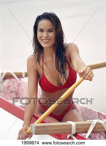 Picture - Close-Up Smiling Woman In Canoe And Paddle, Wearing Red Bikini D1399. Fotosearch