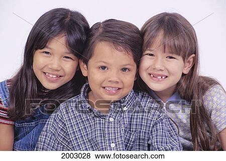 Stock Photo - Close-Up Studio Shot Of The Faces Of Three Young Children, Smiling, White Background. Fotosearch