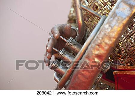 Stock Image - Closeup Of A Man's Fingers Playing A Brass Instrument; Ludhiana, Punjab, India. Fotosearch