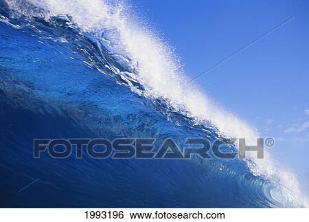 Stock Photograph - Closeup Of Translucent Wave About To Curl With Spray, Blue Skies.. Fotosearch