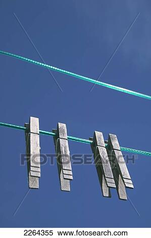 Clothes pegs on a clothesline; ontario canada View Large Photo Image Stock Photography - Clothes pegs on a clothesline; ontario canada. Fotosearch