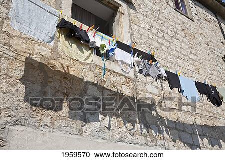 Stock Image - Clothesline Against Building In Trogir, Split-Dalmatia, Croatia. Fotosearch