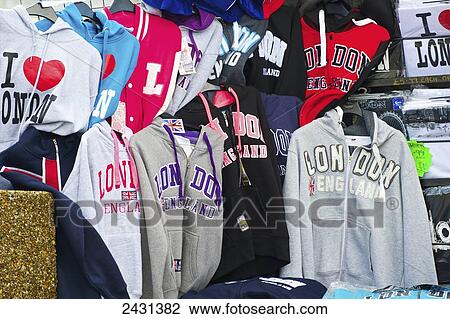Stock Image - Clothing from London displayed for sale; London, England. Fotosearch