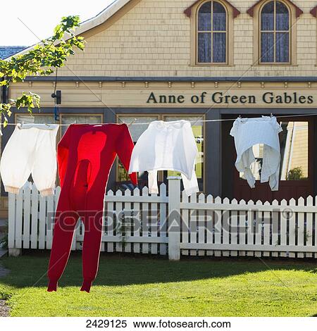 Stock Photography - Clothing hanging on the clothesline in front of a building with an Anne of Green Gables sign; Green Gables, Prince Edward Island, Canada. Fotosearch