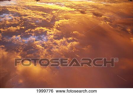Clouds At Sunrise, Golden Orange Pink Tinted, Spectacular C1740 View Large Photo Image Stock Photograph - Clouds At Sunrise, Golden Orange Pink Tinted, Spectacular C1740. Fotosearch