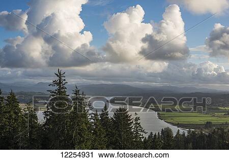 Stock Image - Clouds drift over Youngs Bay; Astoria, Oregon, United States of America. Fotosearch